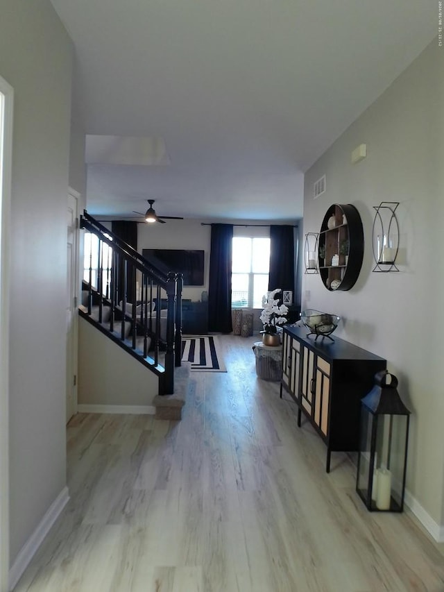 interior space featuring wood-type flooring and ceiling fan