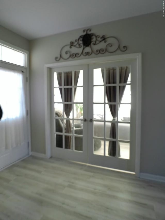 entryway with light hardwood / wood-style flooring and french doors