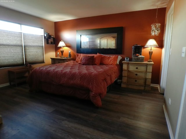 bedroom with dark wood-type flooring