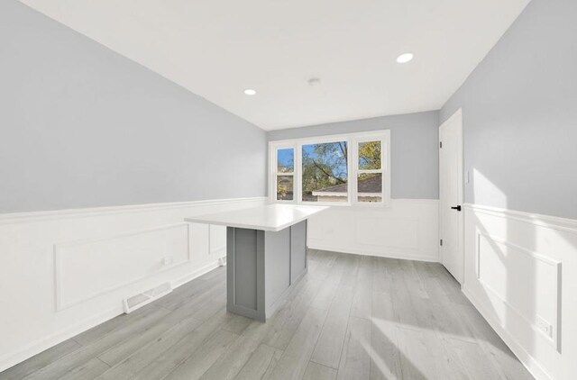 kitchen with dark hardwood / wood-style flooring, light stone countertops, sink, and white cabinets