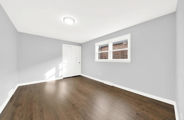 spare room featuring dark hardwood / wood-style floors