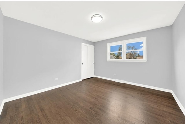 spare room with dark hardwood / wood-style floors