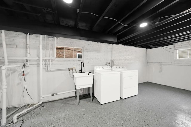 basement featuring sink and washer and dryer