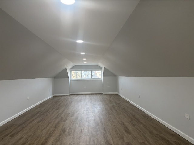 additional living space featuring lofted ceiling and dark hardwood / wood-style floors