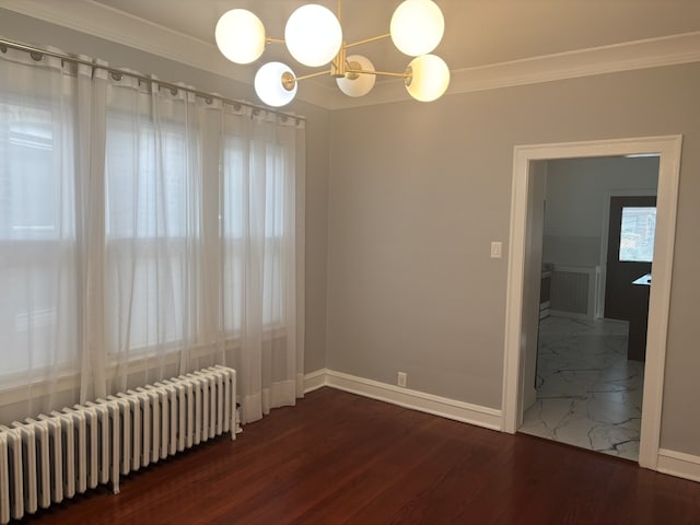 unfurnished room featuring an inviting chandelier, radiator, crown molding, and dark wood-type flooring