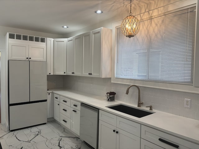 kitchen featuring sink, white cabinetry, refrigerator, hanging light fixtures, and dishwasher