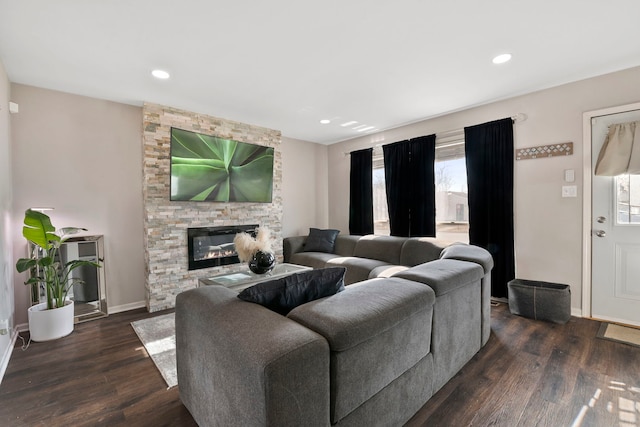 living room with dark hardwood / wood-style floors and a fireplace