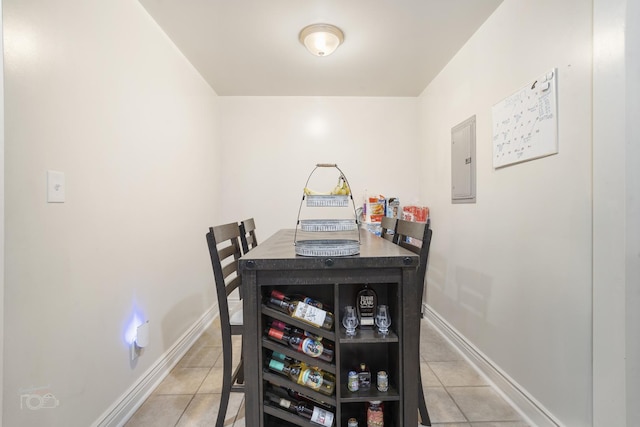 dining area with light tile patterned flooring and electric panel