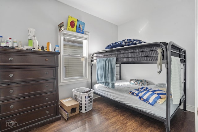 bedroom with multiple windows and dark wood-type flooring