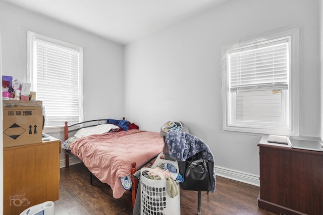 bedroom with dark hardwood / wood-style flooring