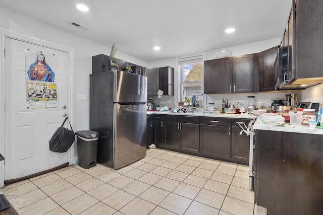 kitchen featuring stainless steel appliances and dark brown cabinetry