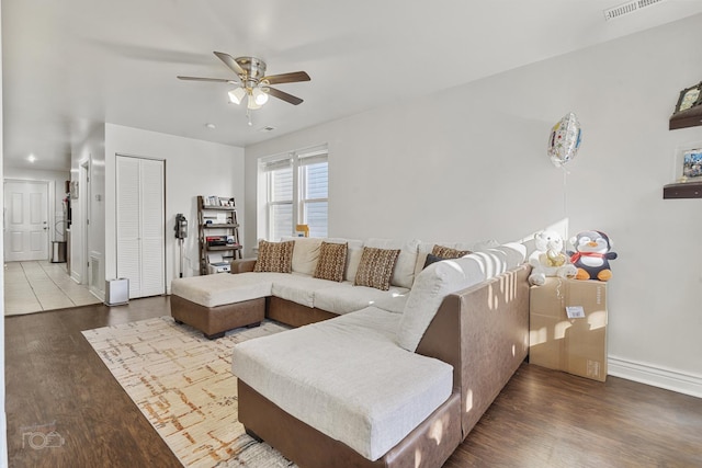 living room with hardwood / wood-style flooring and ceiling fan