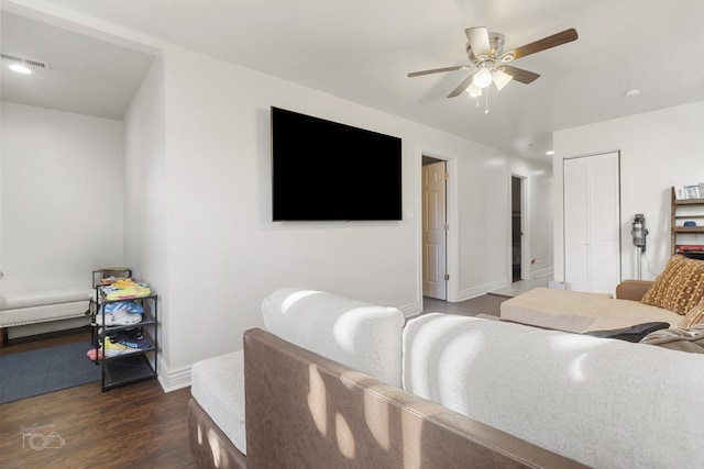 living room with ceiling fan and dark hardwood / wood-style flooring