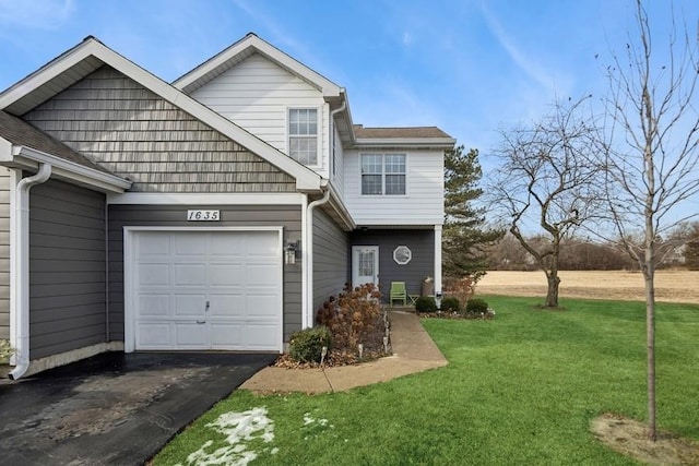 view of front facade with a garage and a front lawn