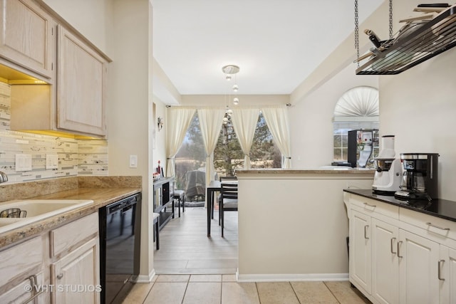 kitchen with light tile patterned floors, sink, dishwasher, tasteful backsplash, and light brown cabinetry