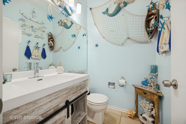 bathroom featuring tile patterned floors, toilet, and vanity