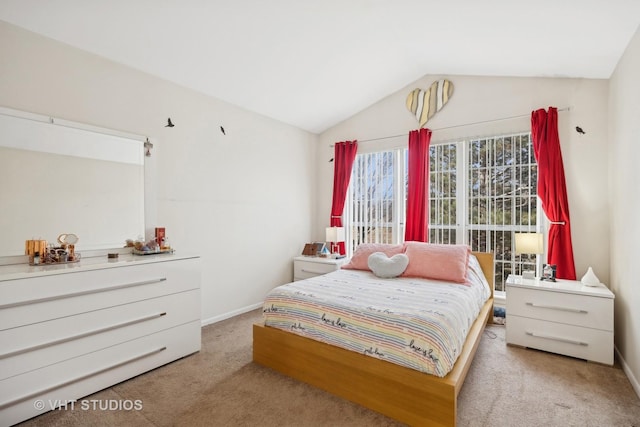 bedroom with vaulted ceiling and light carpet