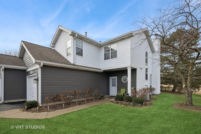 view of front facade with a garage, a front lawn, and central air condition unit