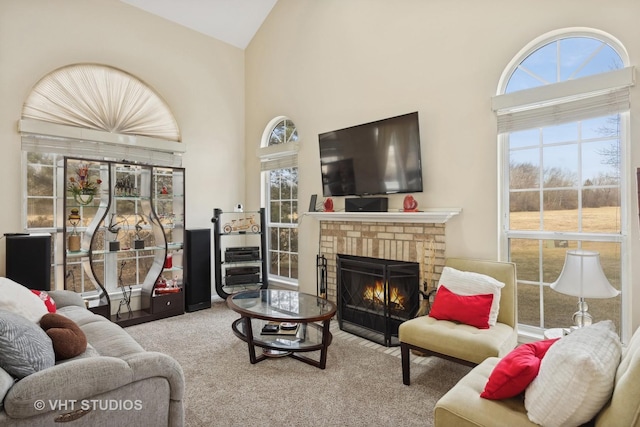 carpeted living room featuring high vaulted ceiling and a fireplace