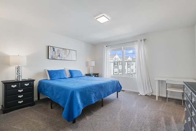 bedroom with dark colored carpet