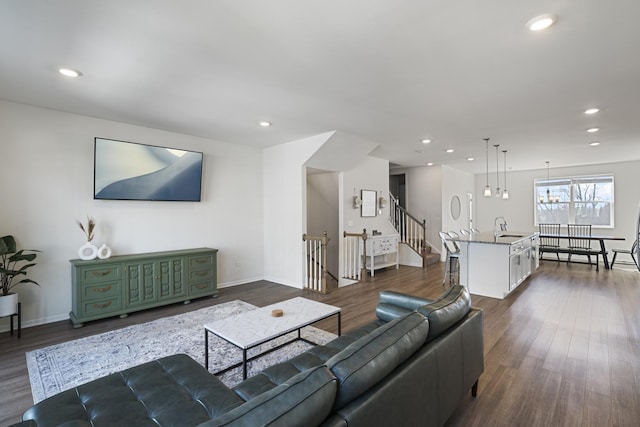 living room with dark hardwood / wood-style flooring and sink