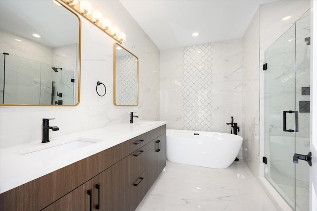 bathroom with tile walls, vanity, and shower with separate bathtub