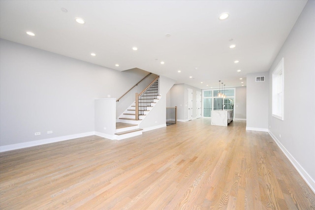 unfurnished living room with light hardwood / wood-style flooring