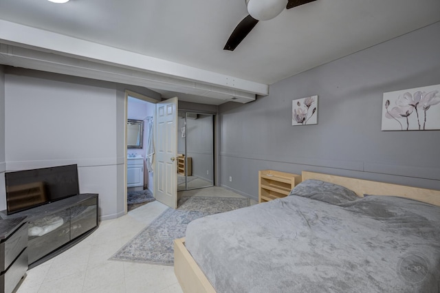 bedroom with beamed ceiling, ceiling fan, and ensuite bathroom