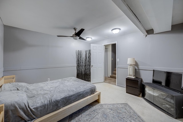 tiled bedroom featuring ceiling fan