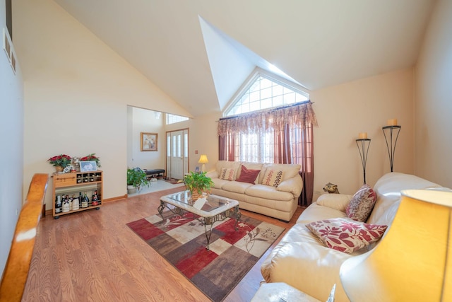 living room featuring hardwood / wood-style floors and high vaulted ceiling