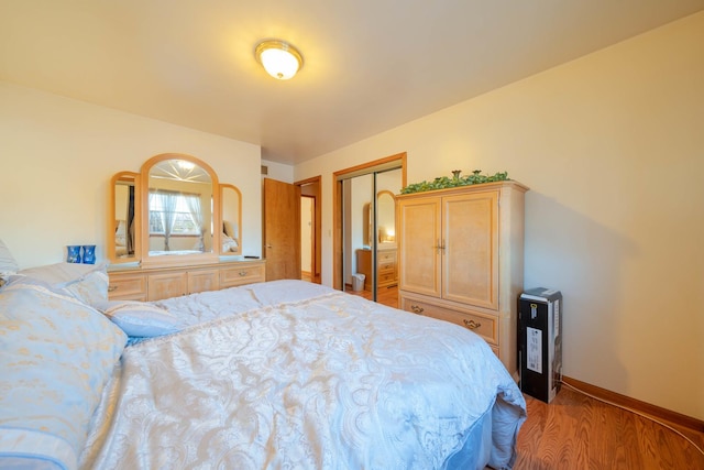 bedroom with hardwood / wood-style flooring and a closet