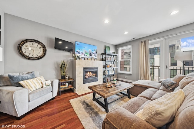 living room featuring dark hardwood / wood-style flooring and a fireplace