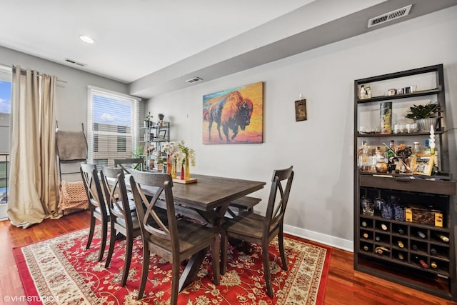 dining space with dark hardwood / wood-style flooring