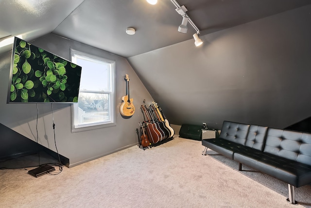 sitting room featuring lofted ceiling, rail lighting, and carpet flooring