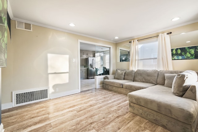 living room with ornamental molding and light wood-type flooring