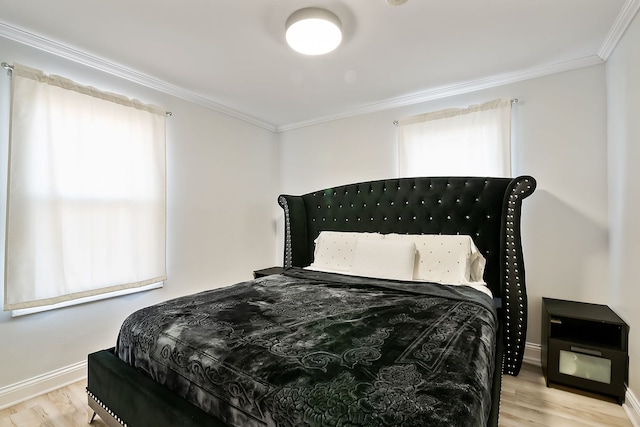 bedroom featuring crown molding and light hardwood / wood-style floors