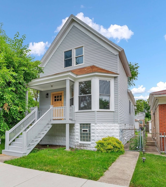 view of front of home with a porch and a front lawn