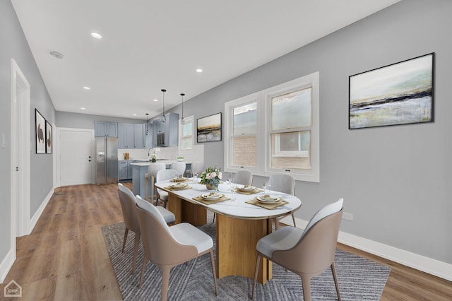 dining space featuring sink and light hardwood / wood-style flooring