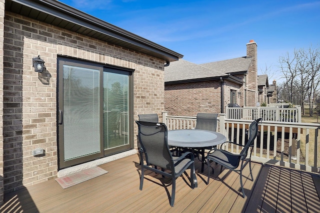 wooden deck featuring outdoor dining area