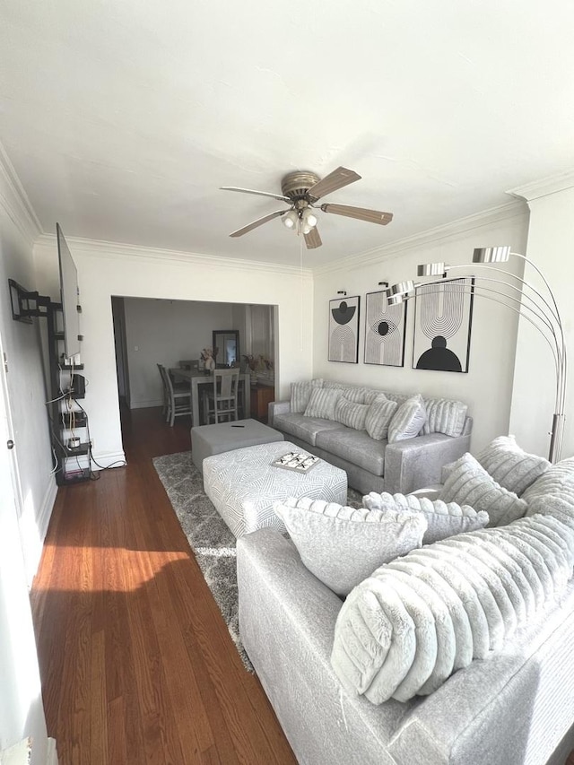 living room with crown molding, ceiling fan, and dark hardwood / wood-style floors