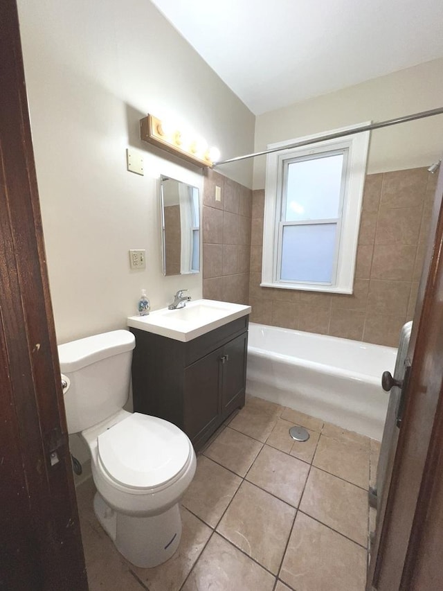 full bathroom featuring tile patterned flooring, vanity, tiled shower / bath combo, and toilet