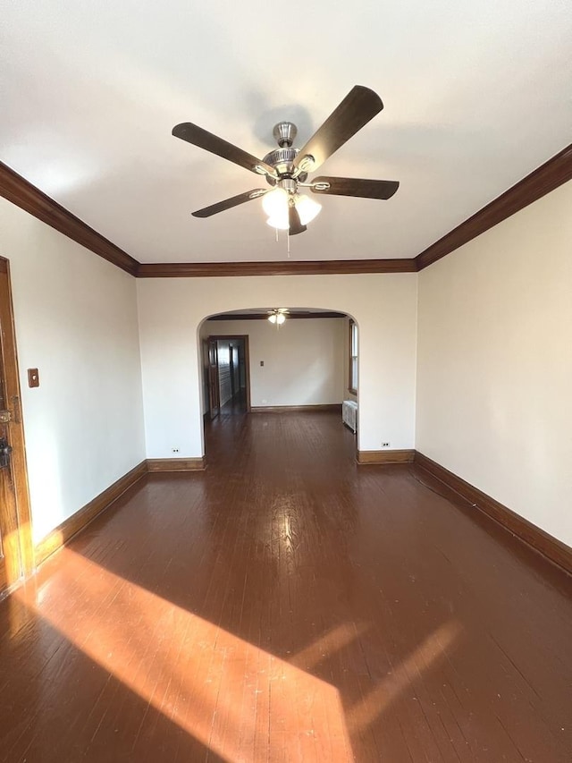 unfurnished room featuring crown molding, dark wood-type flooring, and ceiling fan