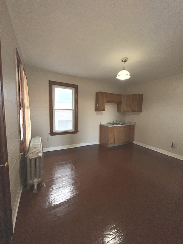 unfurnished living room featuring radiator heating unit and dark hardwood / wood-style floors