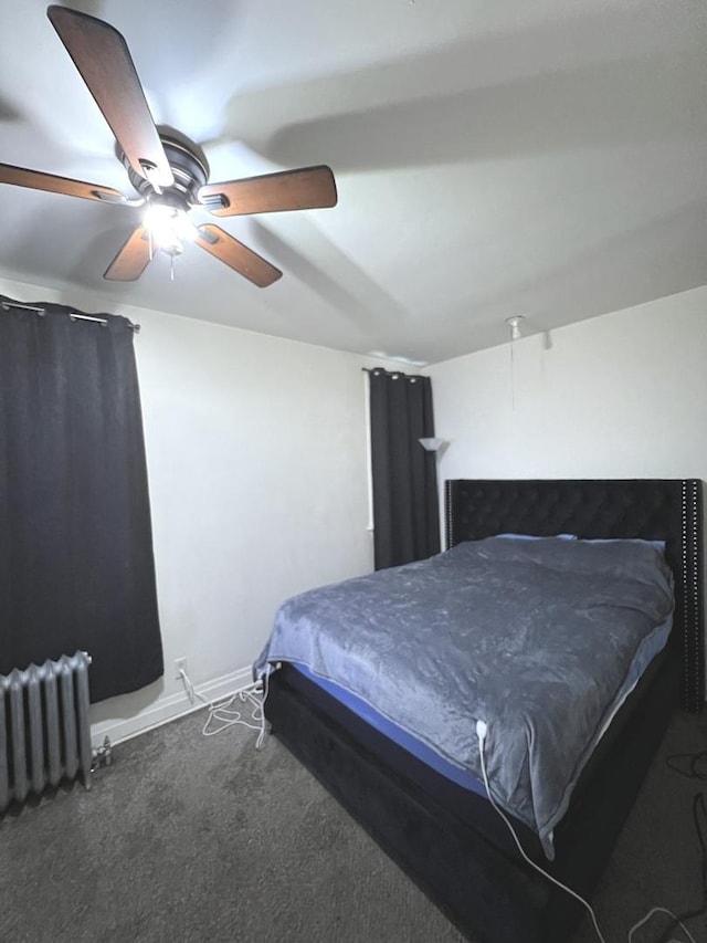 bedroom with dark carpet, radiator heating unit, and ceiling fan