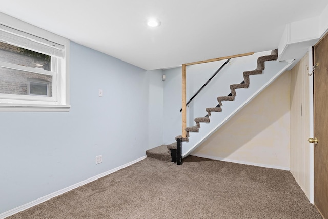 finished below grade area featuring stairs, recessed lighting, carpet, and baseboards