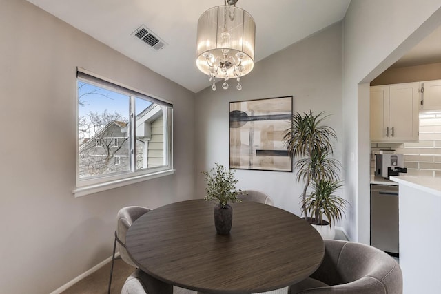 dining space featuring a chandelier and vaulted ceiling