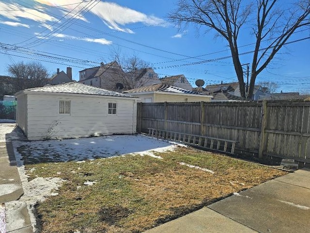 view of yard with an outdoor structure and a fenced backyard