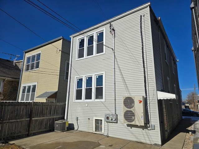 back of house featuring central AC unit, ac unit, fence, and a patio