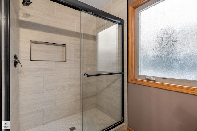 bathroom with a shower with shower door