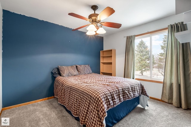 bedroom with ceiling fan, carpet flooring, and multiple windows